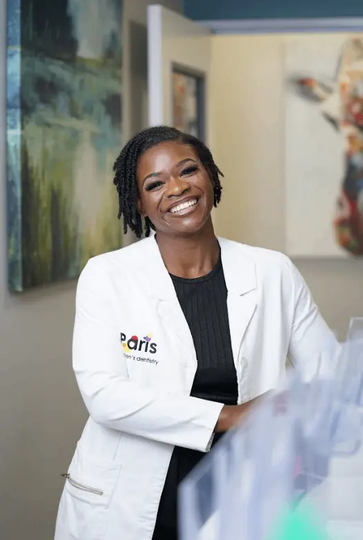 Dr. Shaneka Scott smiling in her Paris Children’s Dentistry coat