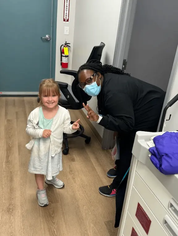 Paris Children’s Dentistry team member providing gentle dental care to a young patient