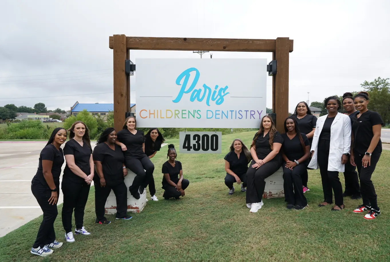 Paris Children’s Dentistry staff outside the office sign