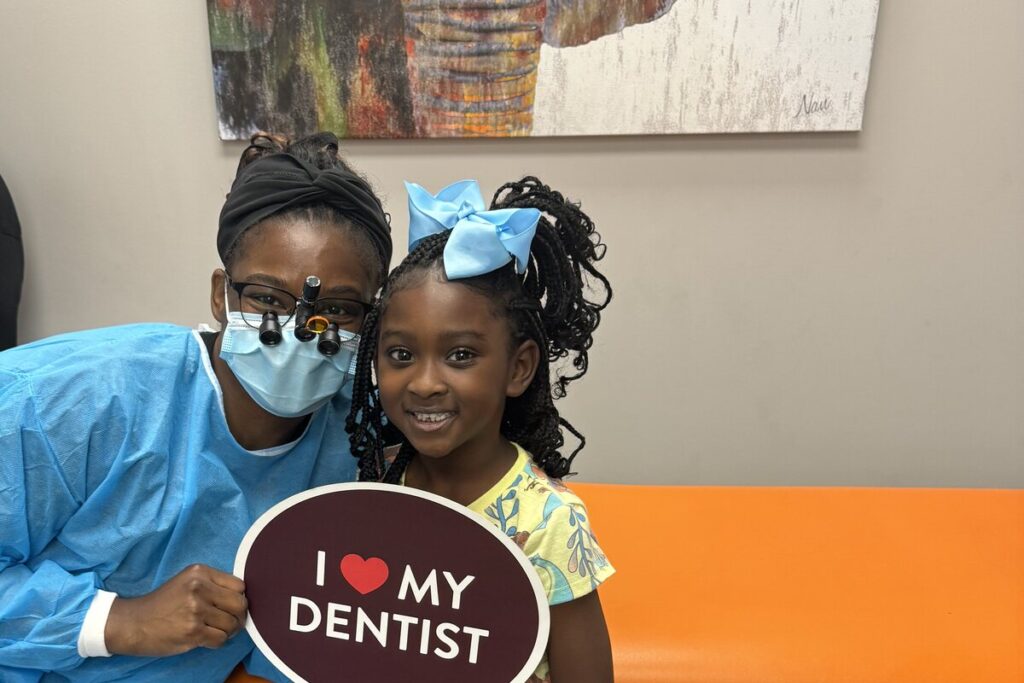 Dr. Shaneka Scott with a smiling young patient at Paris Children’s Dentistry in Paris, Texas